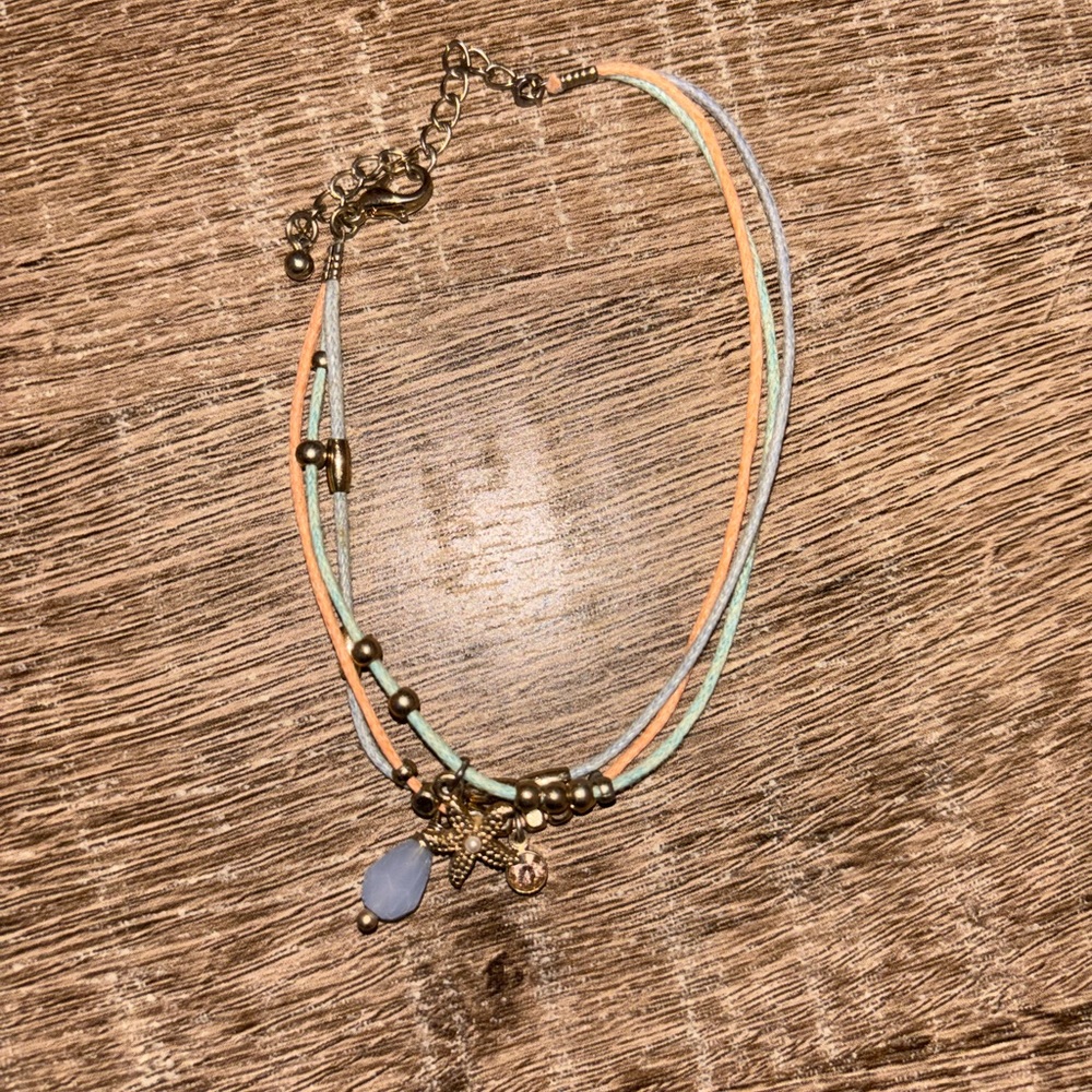 Like new three string bracelet with charms